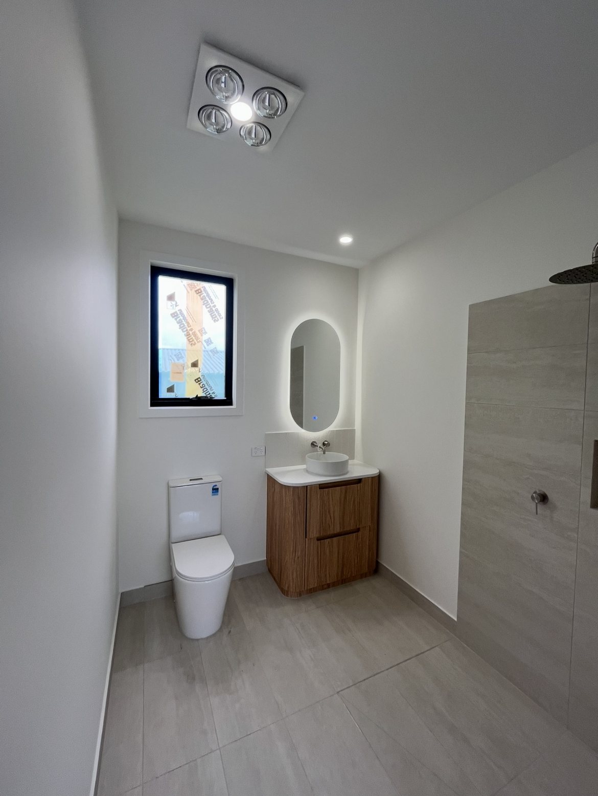 Somerville new build bathroom with backlit mirror and heat lamp